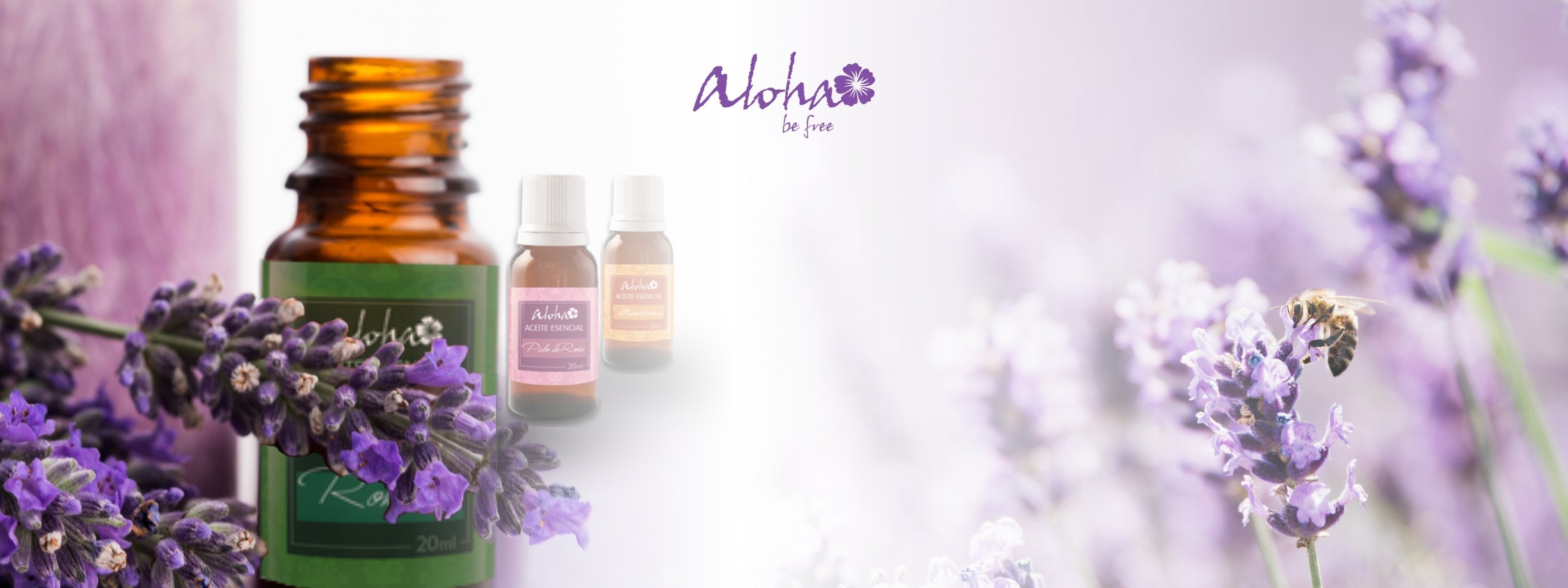 A harmonious blend of nature and wellness, featuring an amber essential oil bottle nestled among fresh lavender sprigs. Two smaller essential oil bottles float softly in the background, enhancing the dreamy, ethereal aesthetic. A bee delicately perches on a lavender bloom, symbolizing the purity and vitality of nature’s essence. The "Aloha be free" logo in a soft lavender hue ties the scene together, exuding tranquility and well-being.